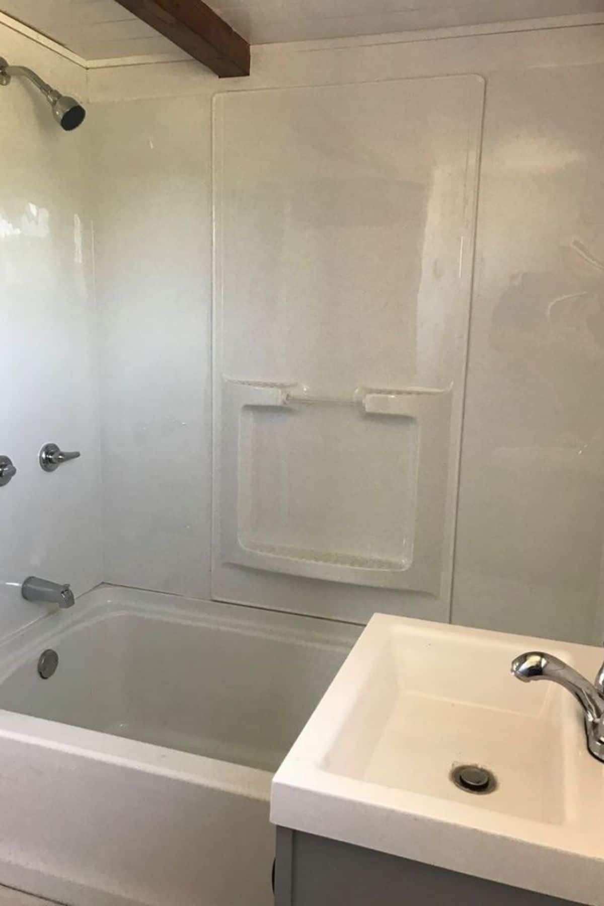 Bathtub with shower inset and wall shelves