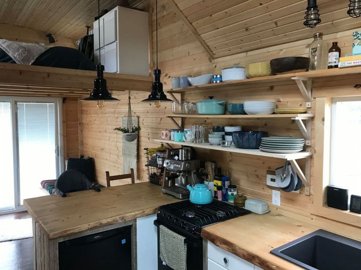 Kitchen in tiny home with wood walls