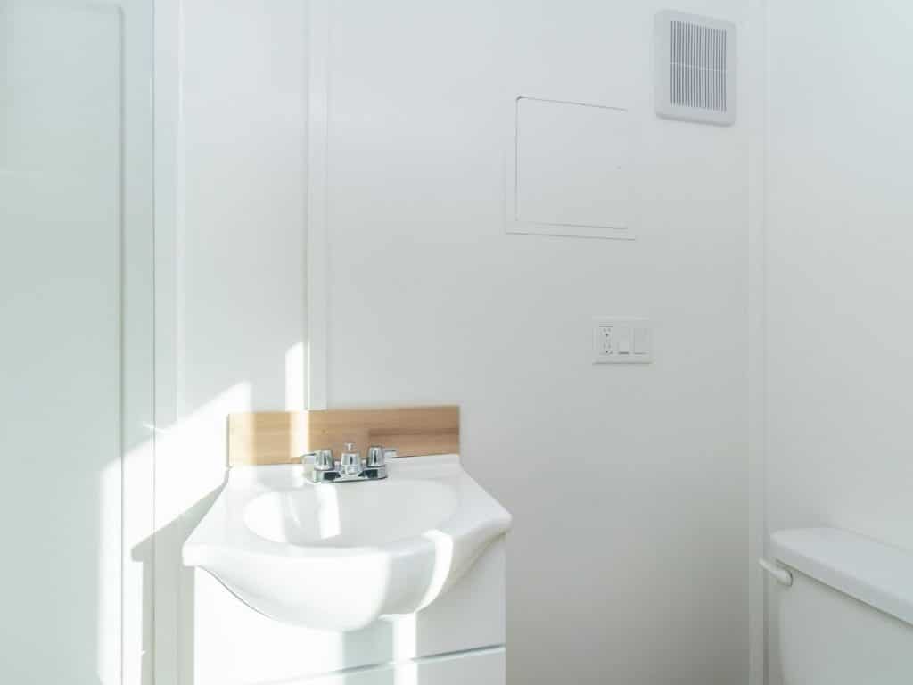 White walls with white sink in tiny bathroom