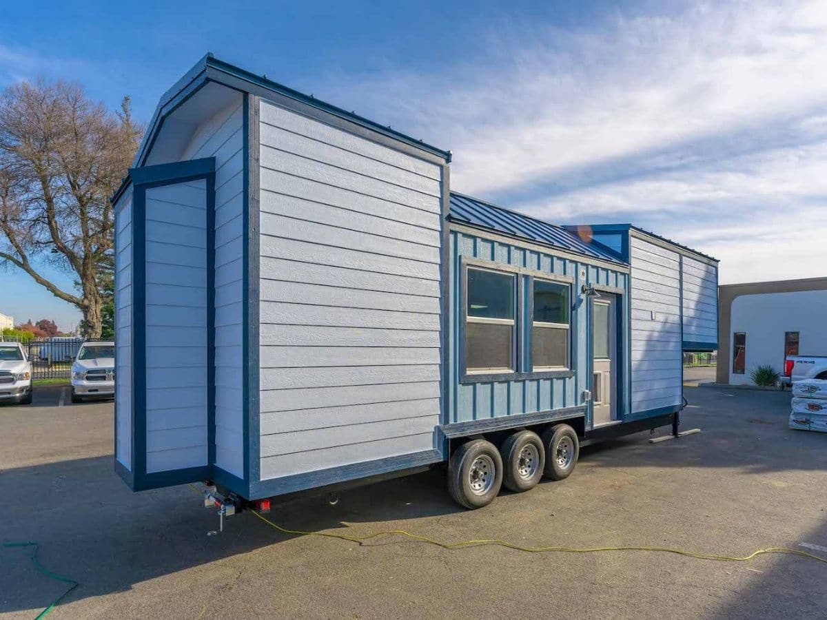 Front angle of blue tiny home on wheels