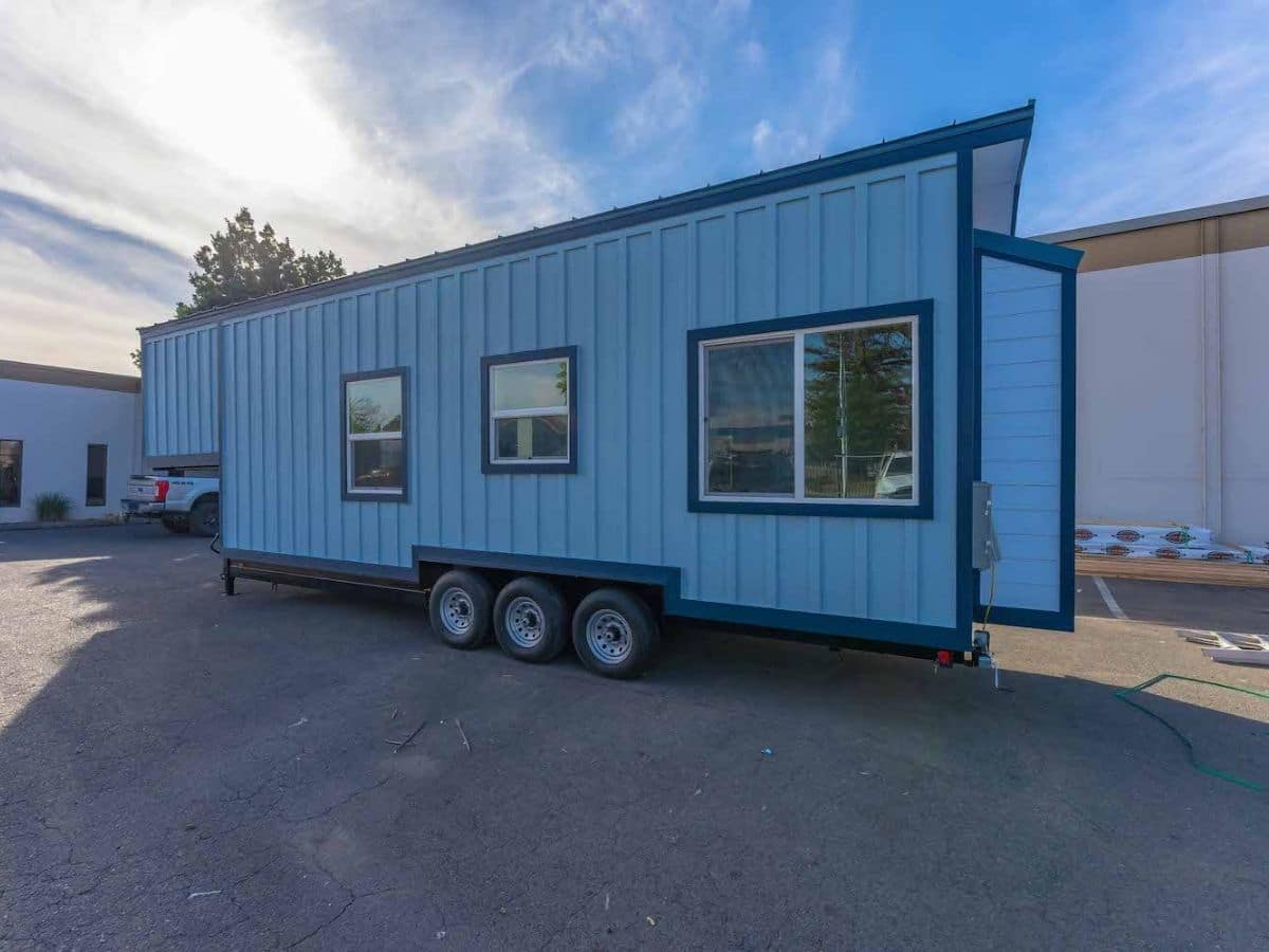 Back side of tiny home with blue siding