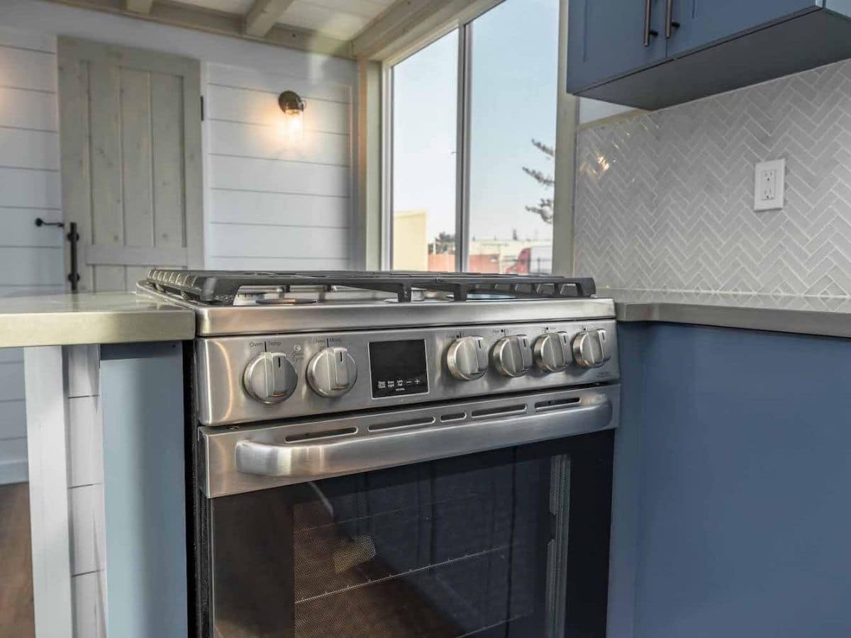 Stainless steel stove in blue cabinets