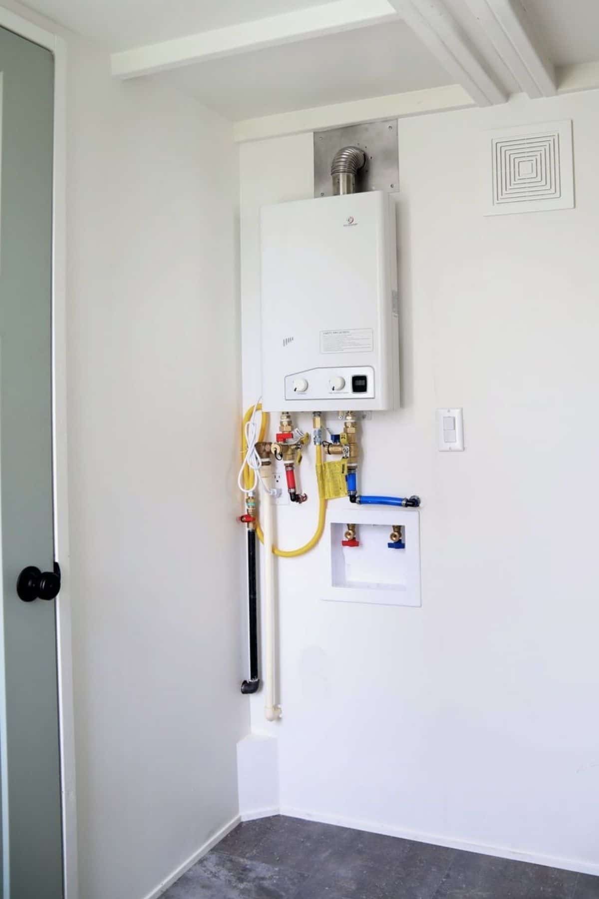 Hot water heater and electrical panel in bathroom