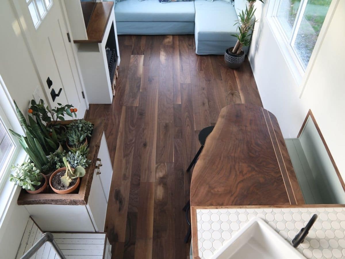 View of hardwood floors from loft in tiny home