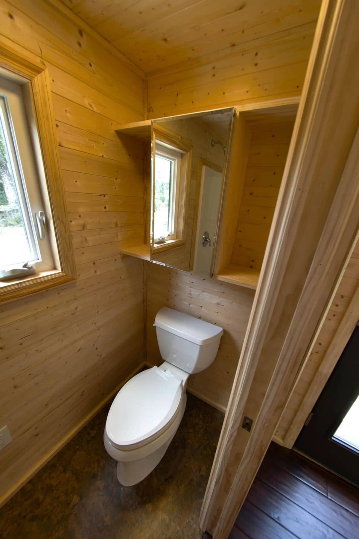 Traditional toilet in tiny wood bathroom