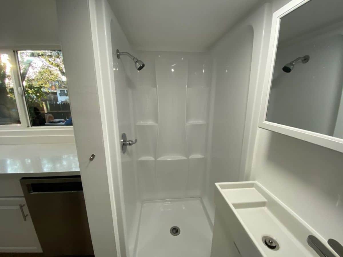 white shower stall with built-in shelves
