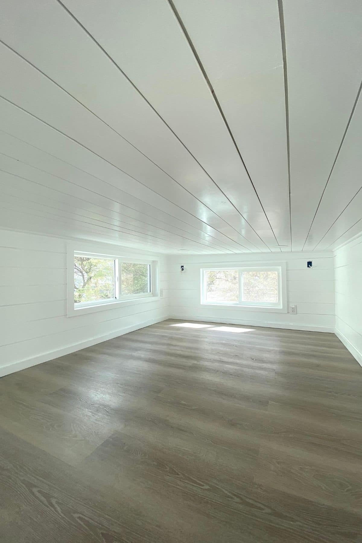Large loft with white walls and light wood flooring