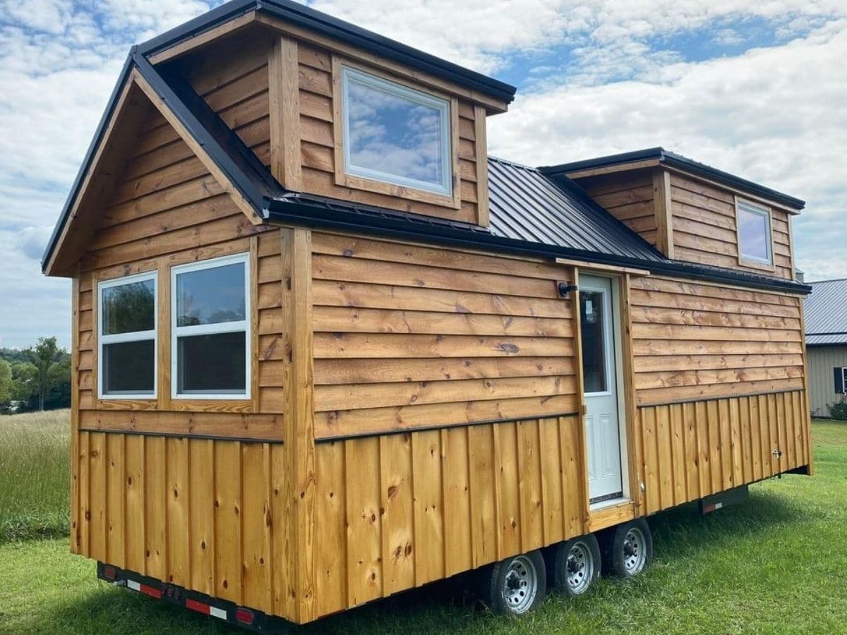 Log cabin tiny house with two lofts