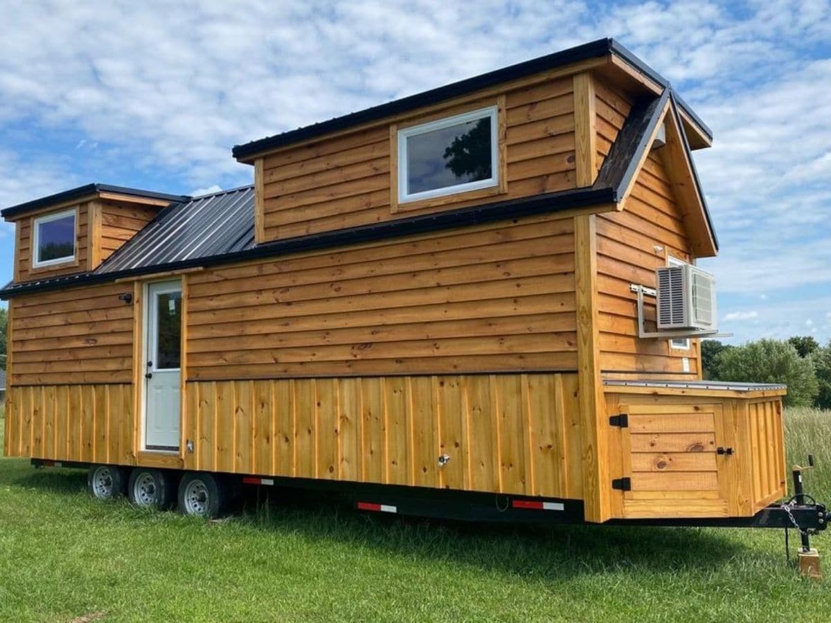 Log cabin tiny house on wheels with tall lofts