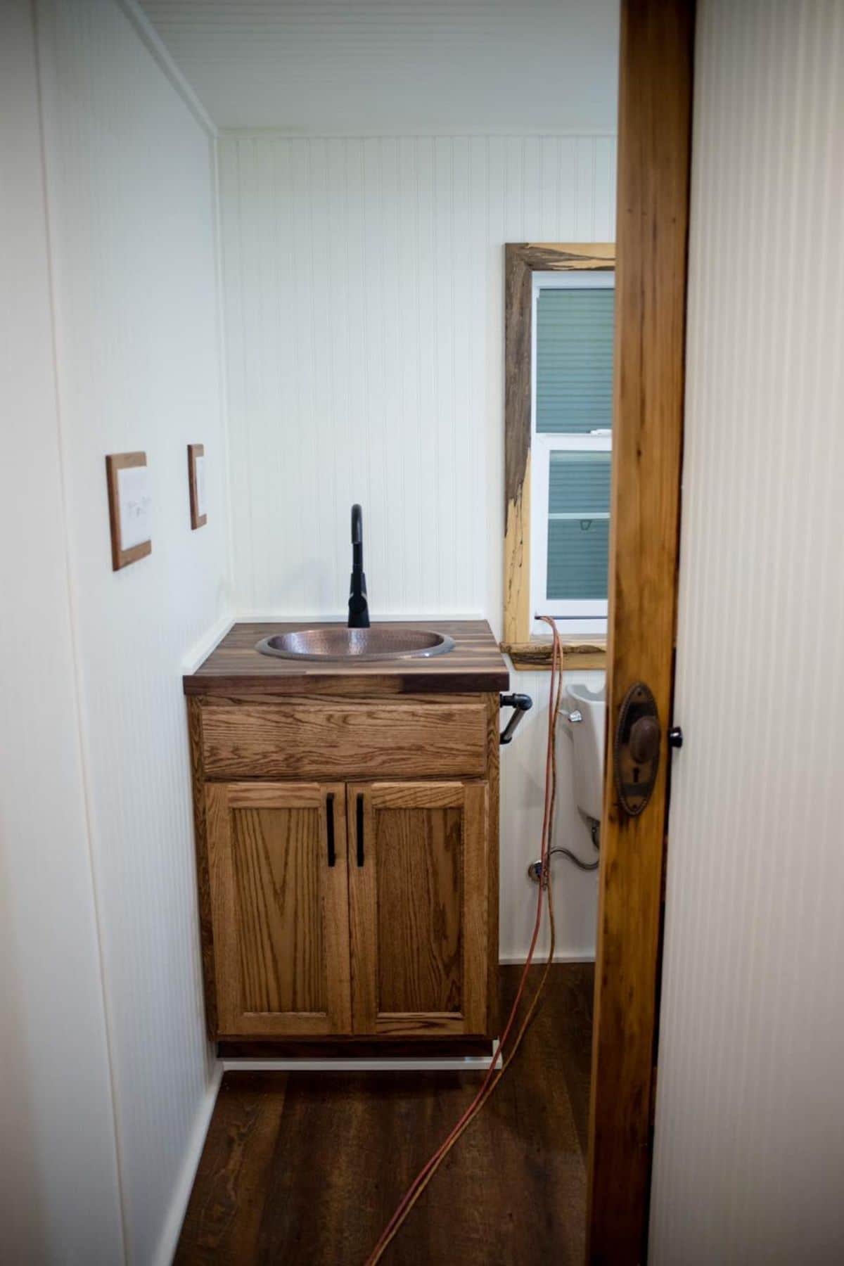 wooden bathroom cabinet against wall