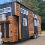 wood tiny home with black siding trim