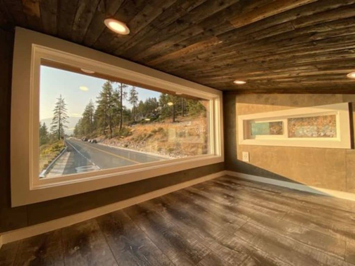 loft window with wood floor and ceiling
