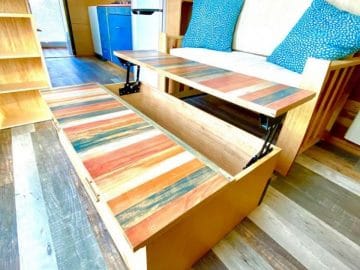Reclaimed wood bench seat with blue pillows