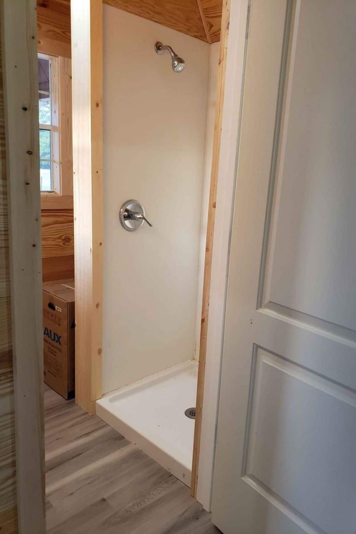 white shower stall through white door