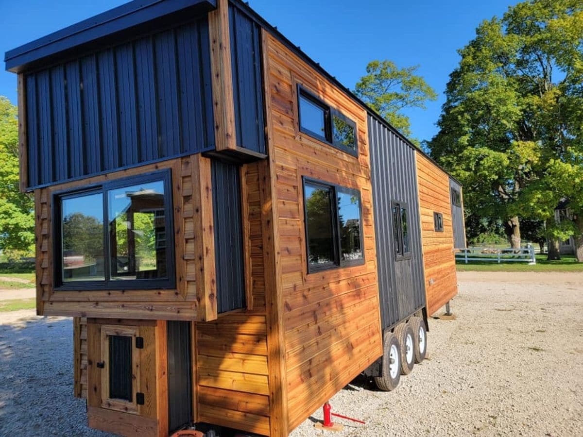 end of tiny home with wood siding and black trim