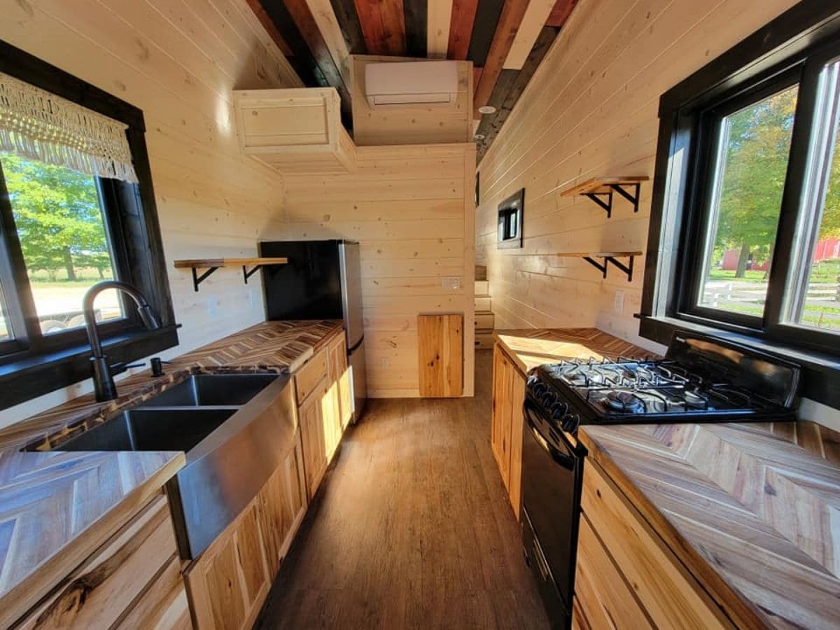 kitchen inside tiny home with stove on right and sink on left