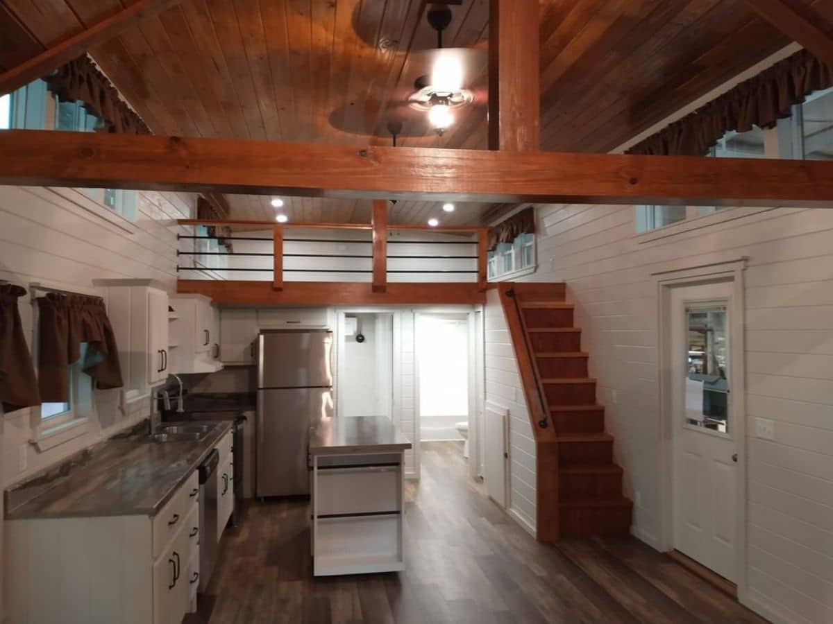 view into kitchen with loft above and stairs on right