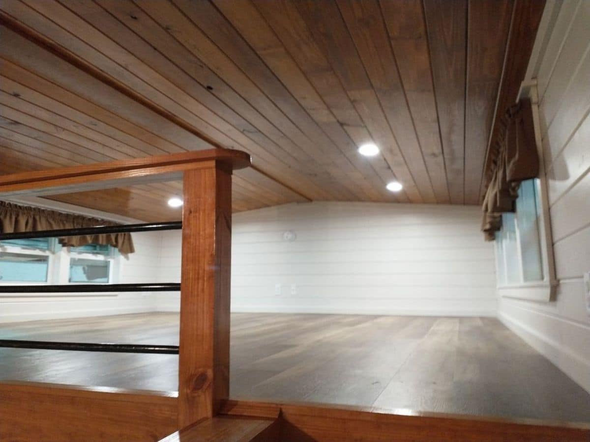 wood ceiling and floor with white walls in loft