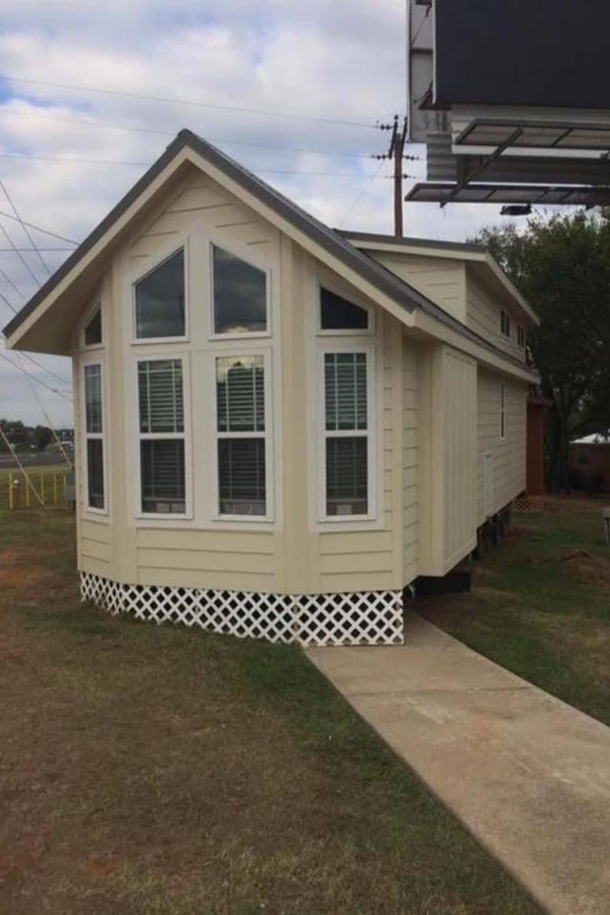 cream tiny home with bay window on front