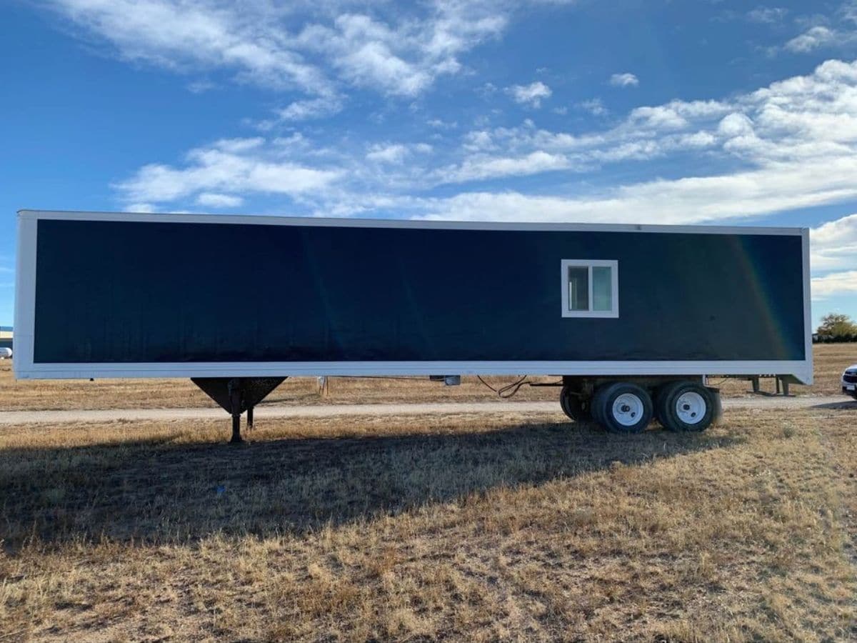 blue semi trailer with windows on side