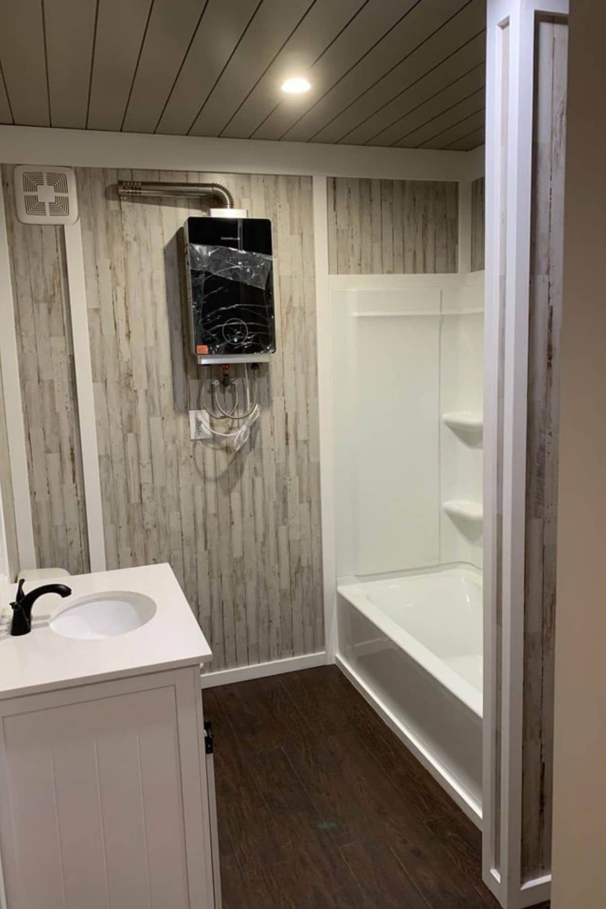 white shower stall against gray and white paneling