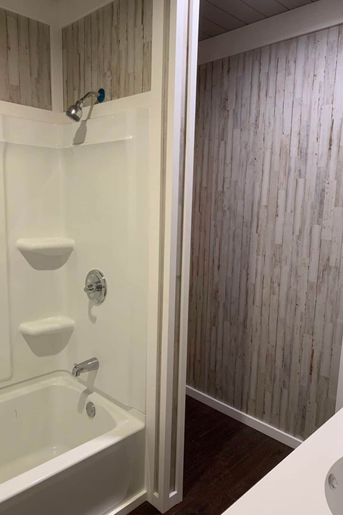 white shower stall with space beside for storage