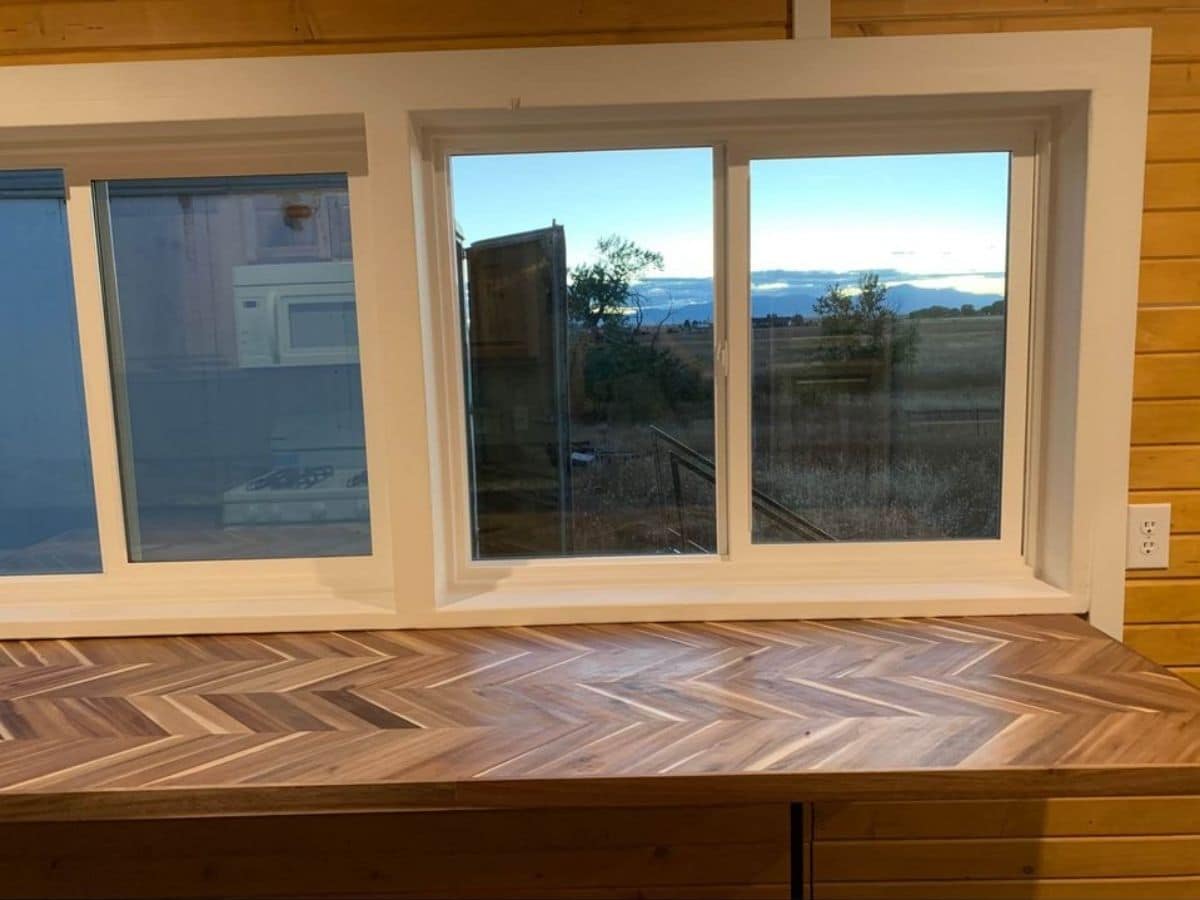 custom wood inlay table underneath white windows