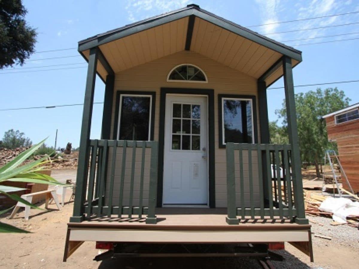 front porch of light brown tiny house