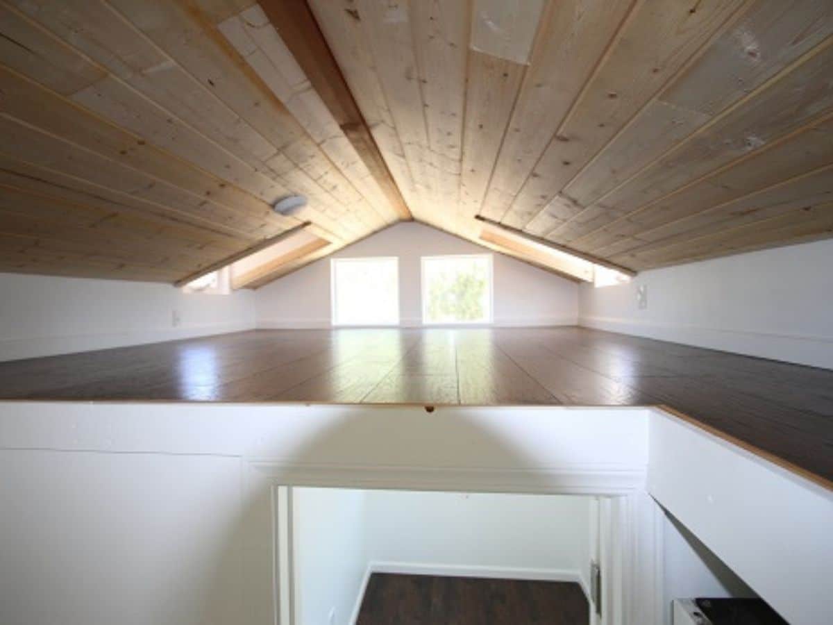 loft above bathroom with wood floor and ceiling