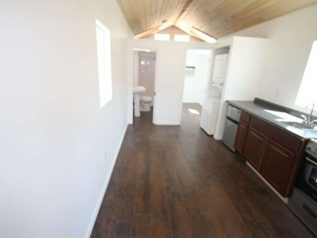 empty entry in tiny home with white walls and wood floors