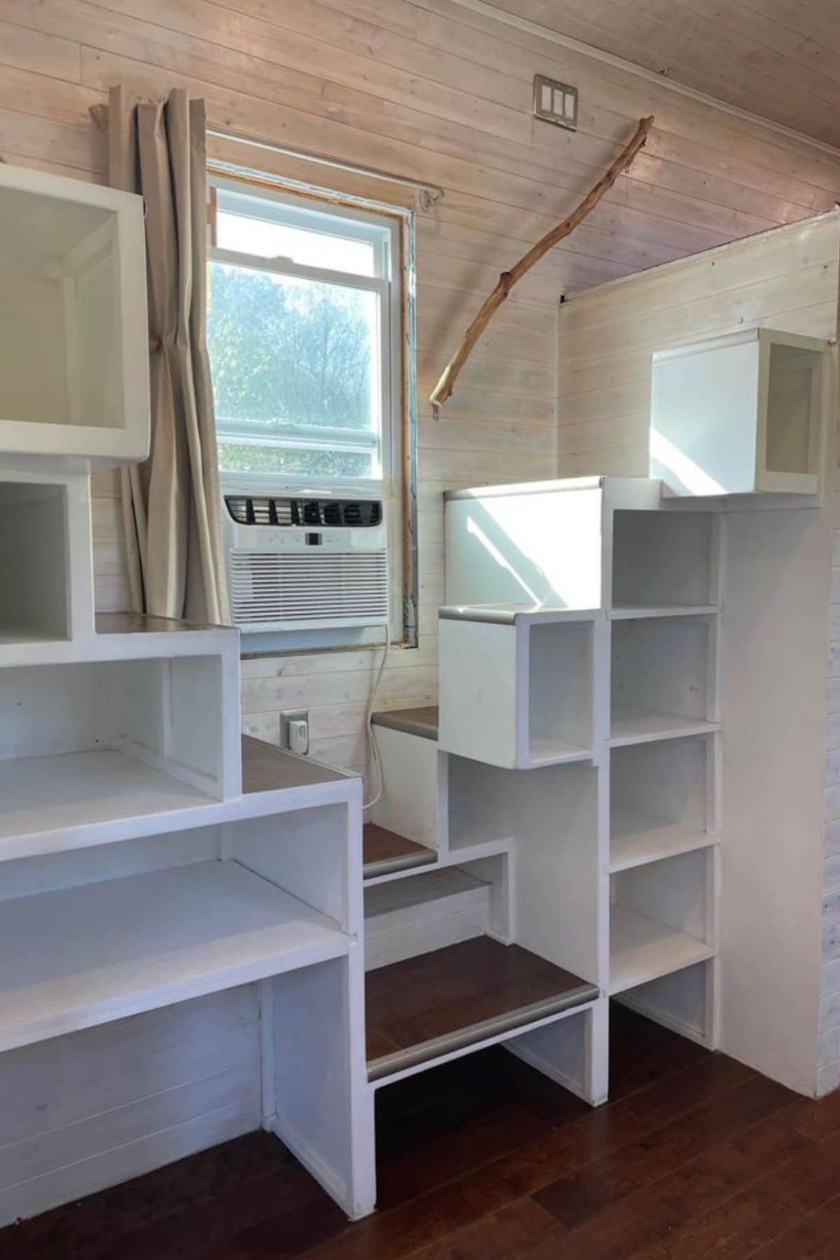 white cubby stairs to lofts against white wall