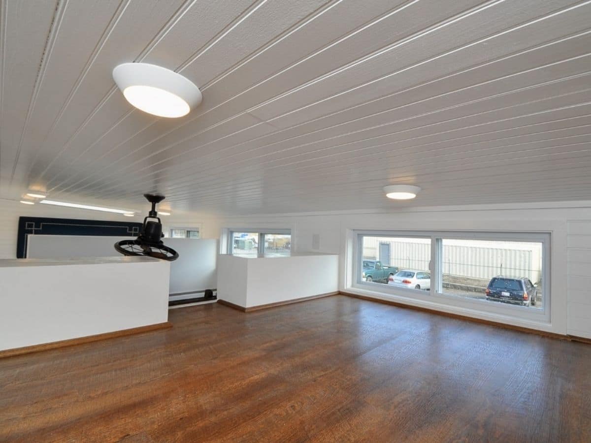 wood floors in loft with white wall and ceiling