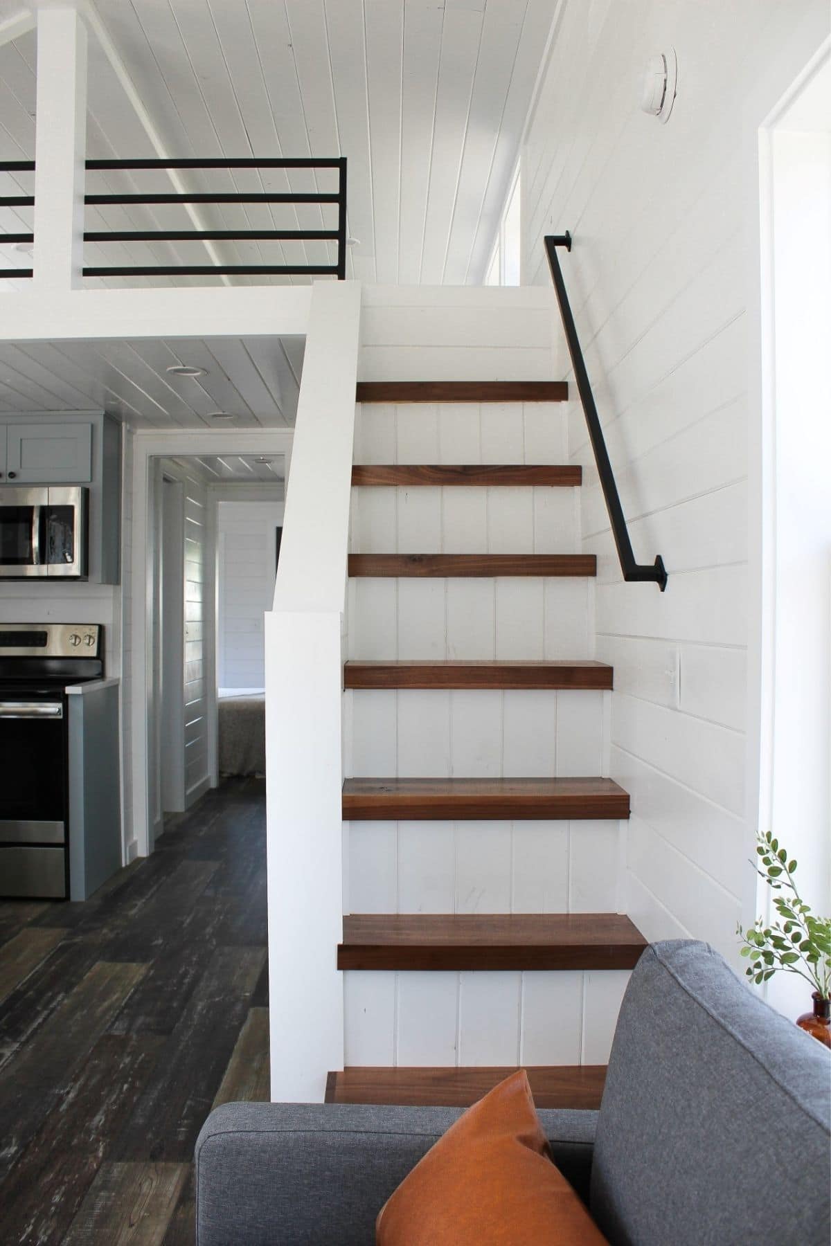 white stairs with wood top and railing on wall
