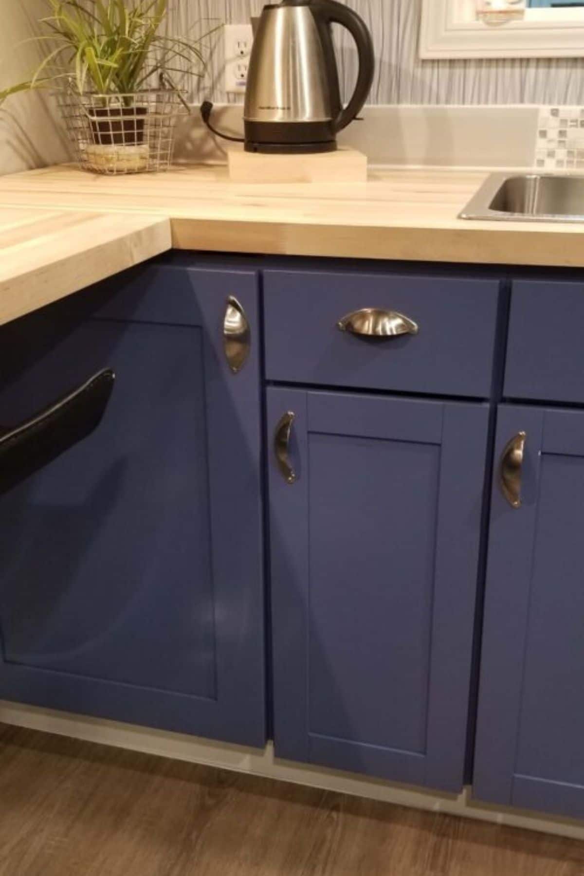 blue cabinets under butcherblock counter