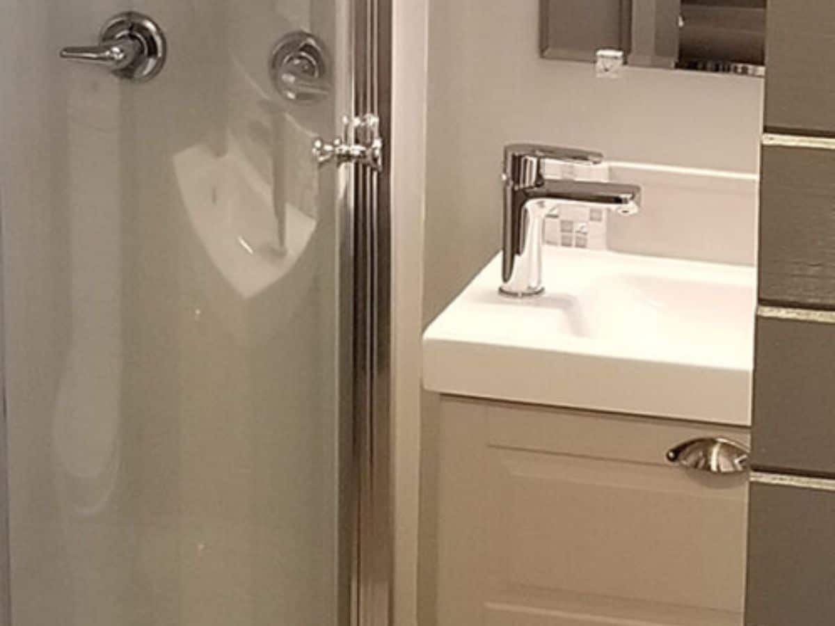 glass shower on left and sink on right