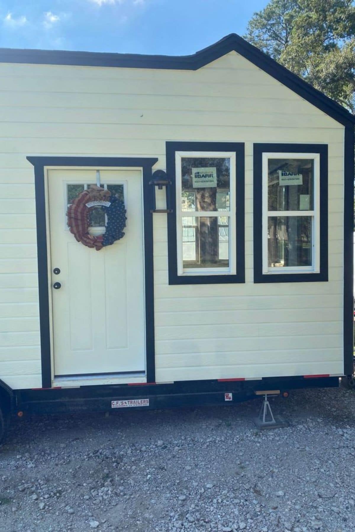 front door with wreath on white tiny home