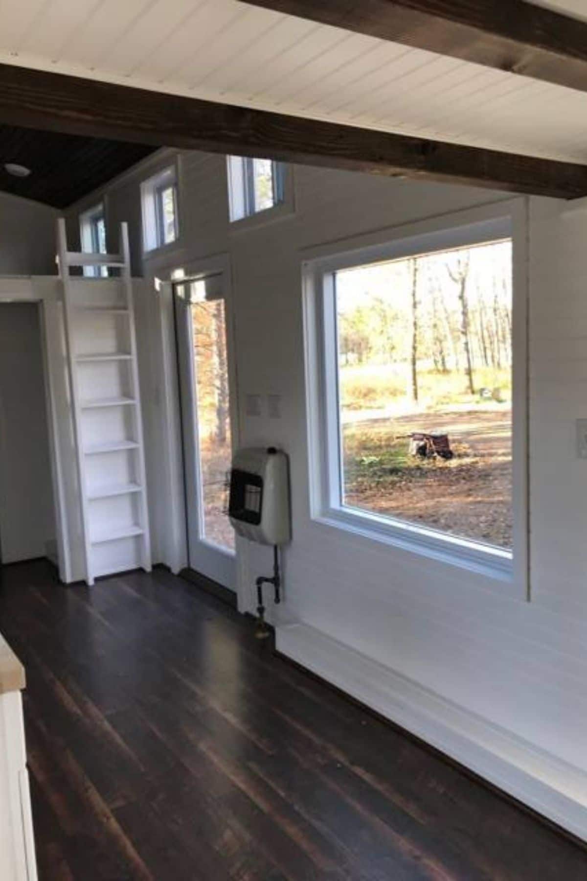 front door and large window to right of image inside tinyhome