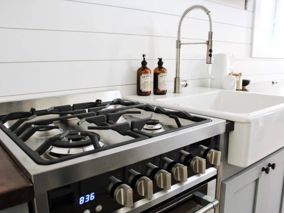 stainless steel gast stove by white farmhouse sink