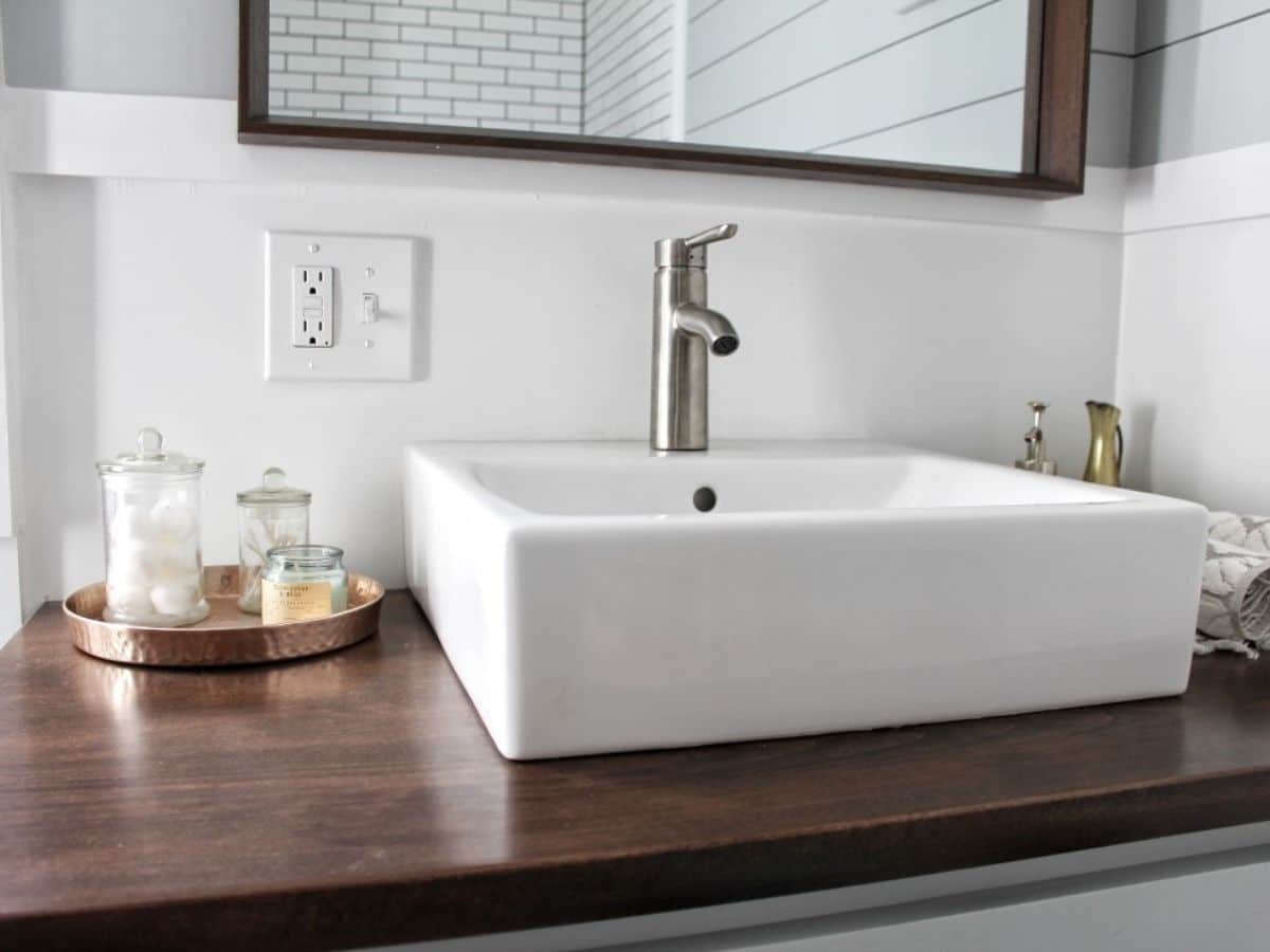 white bowl sink above wood countertops