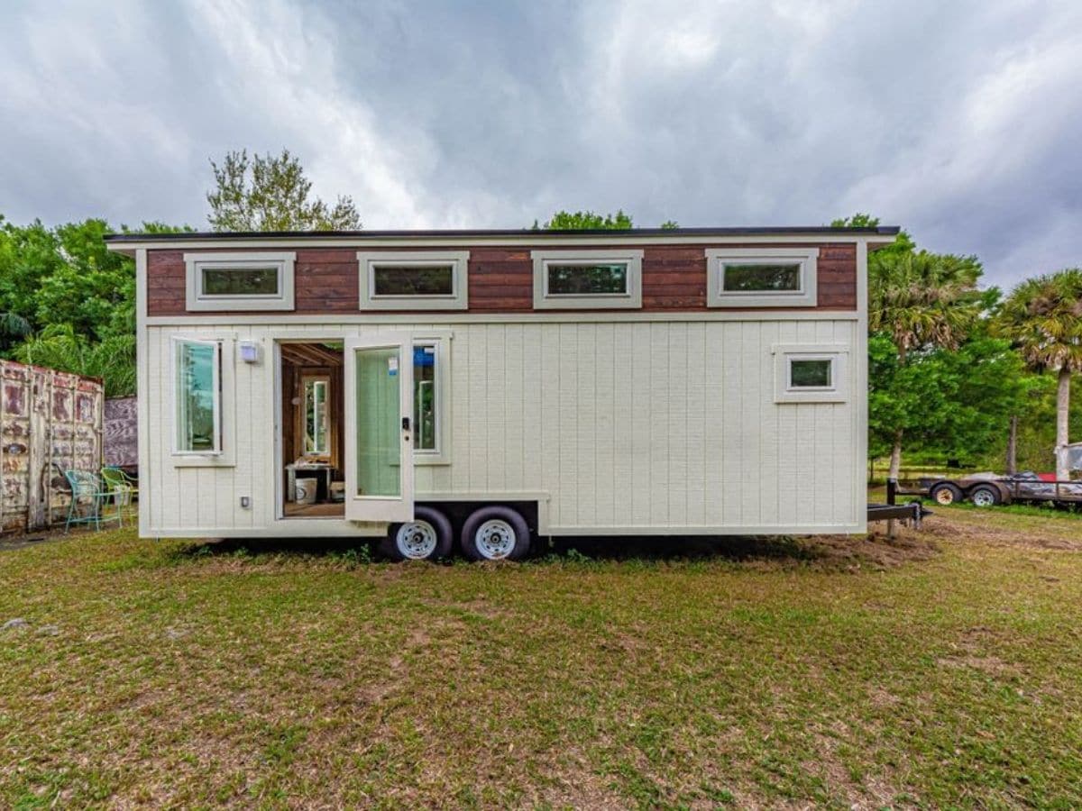 white and wood tiny house with door open