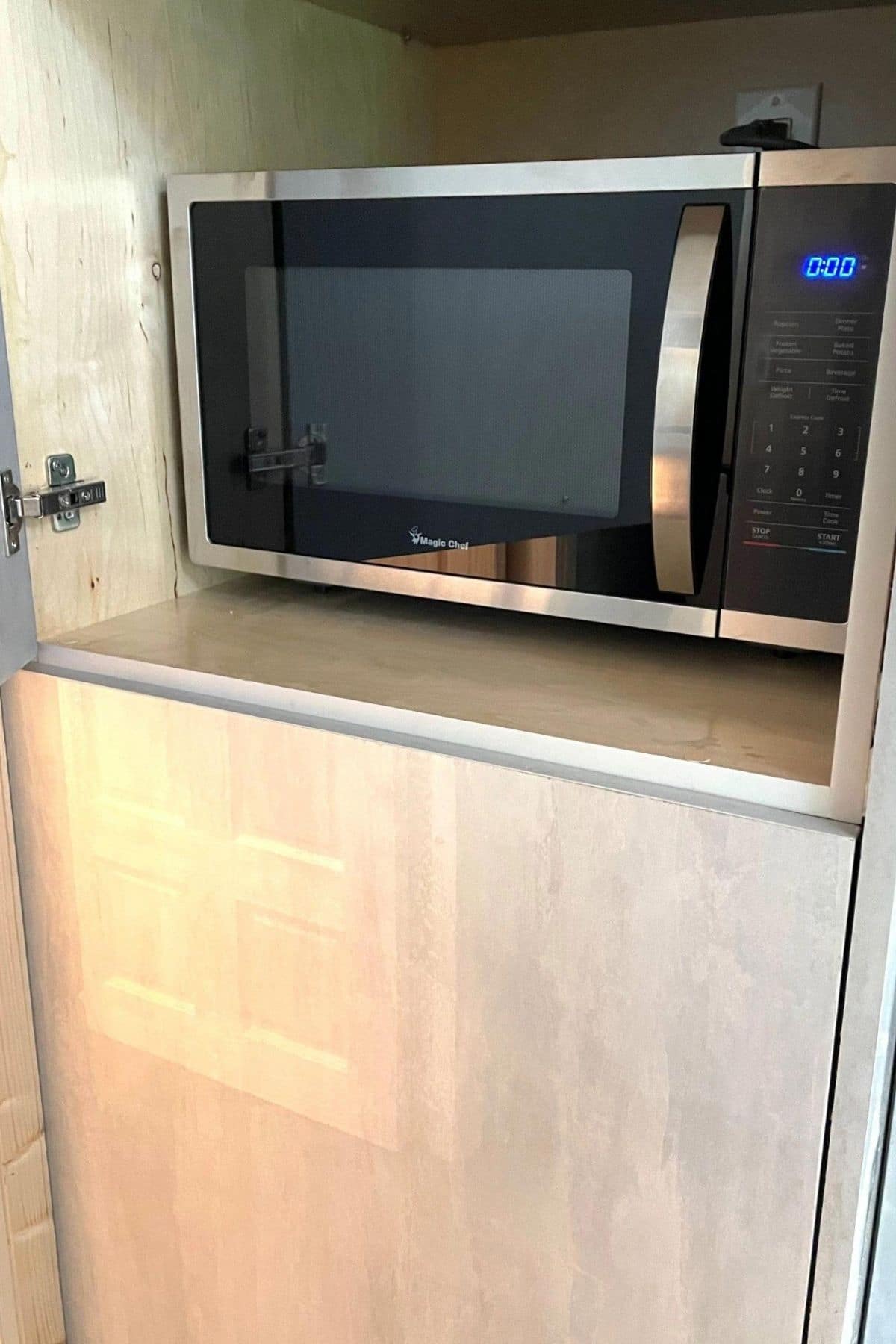 microwave in cupboard in kitchen