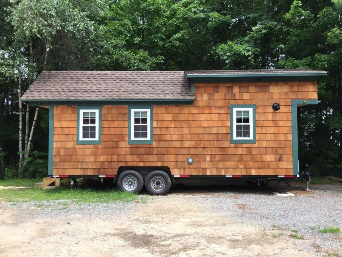 side of cedar tiny home with three windows