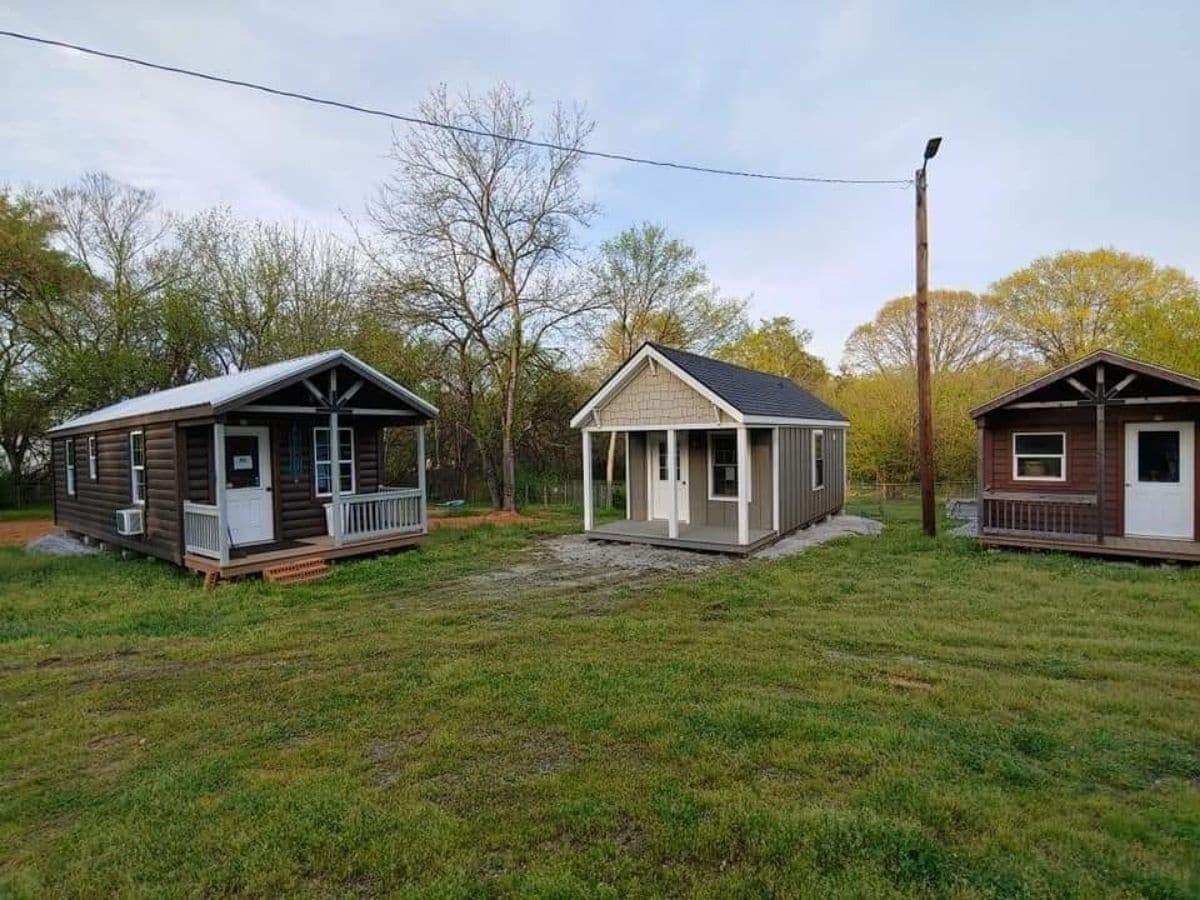 three tiny houses in a row on lawn