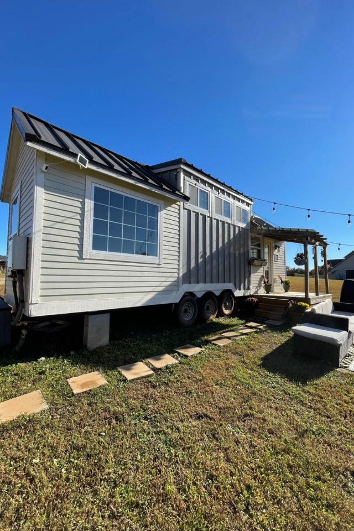 side of tiny home with picture window on end