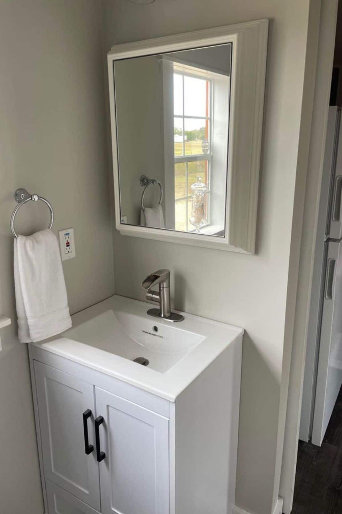 white vanity with sink and medicine cabinet above