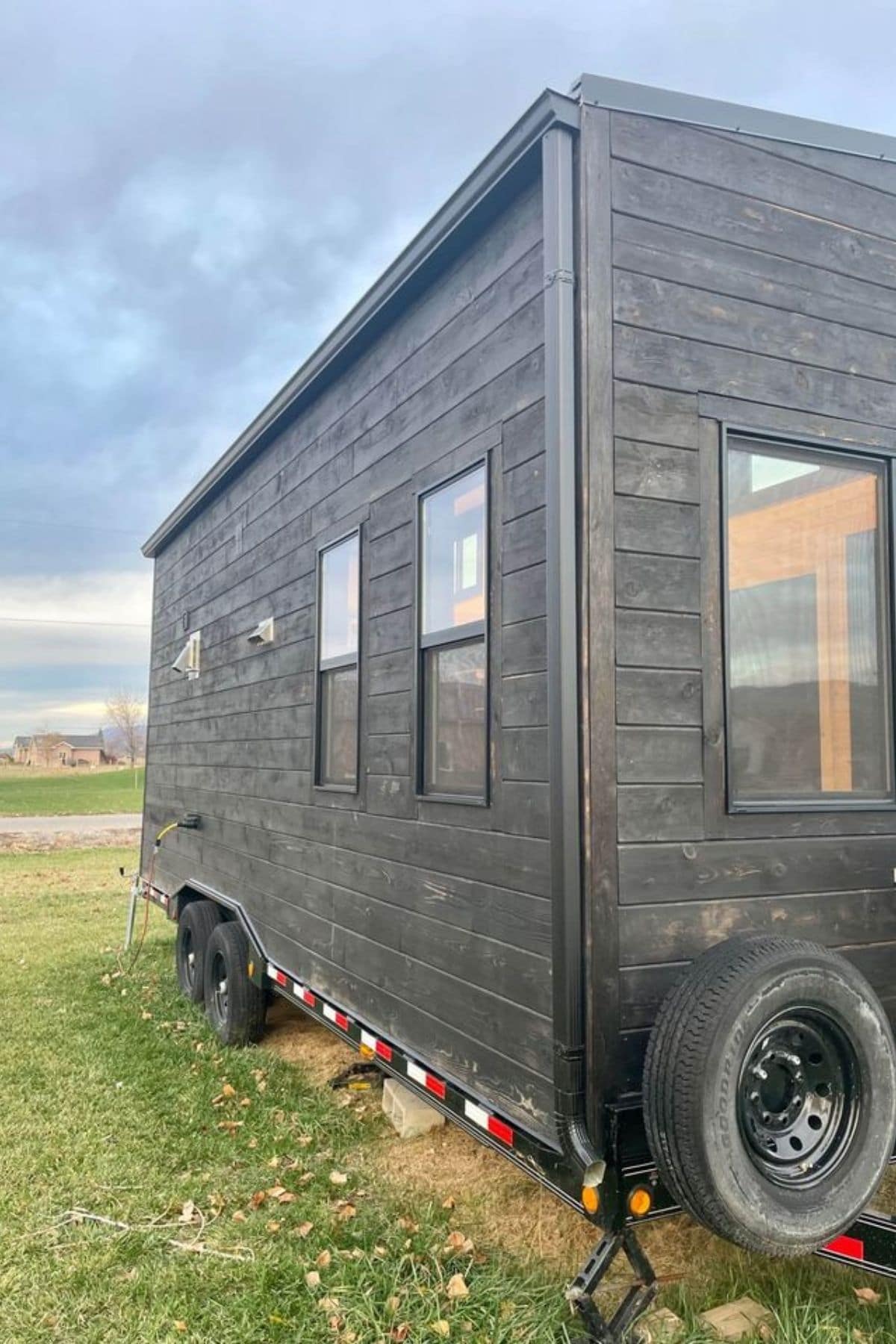 back side of tiny home with black stained wood siding