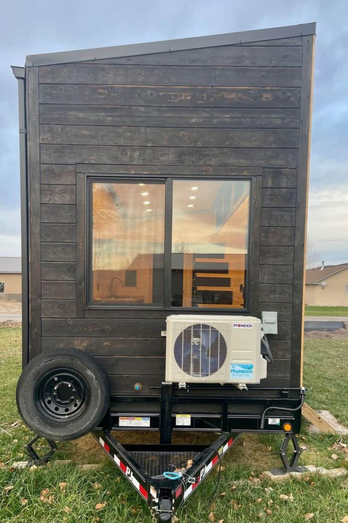 back of tiny house with air conditioner below windows