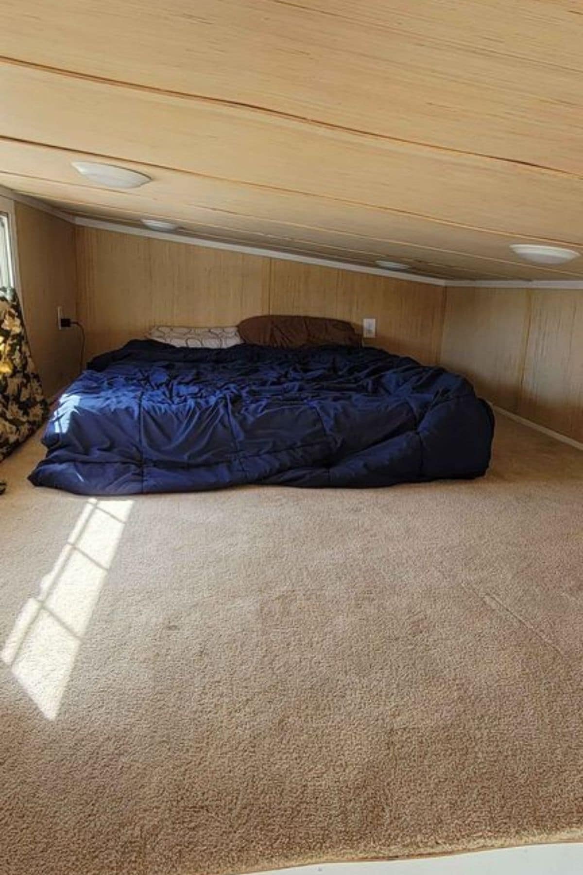loft with blue bed at back of space