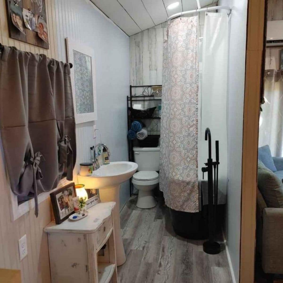 bathroom with shower on right and toilet on back wall