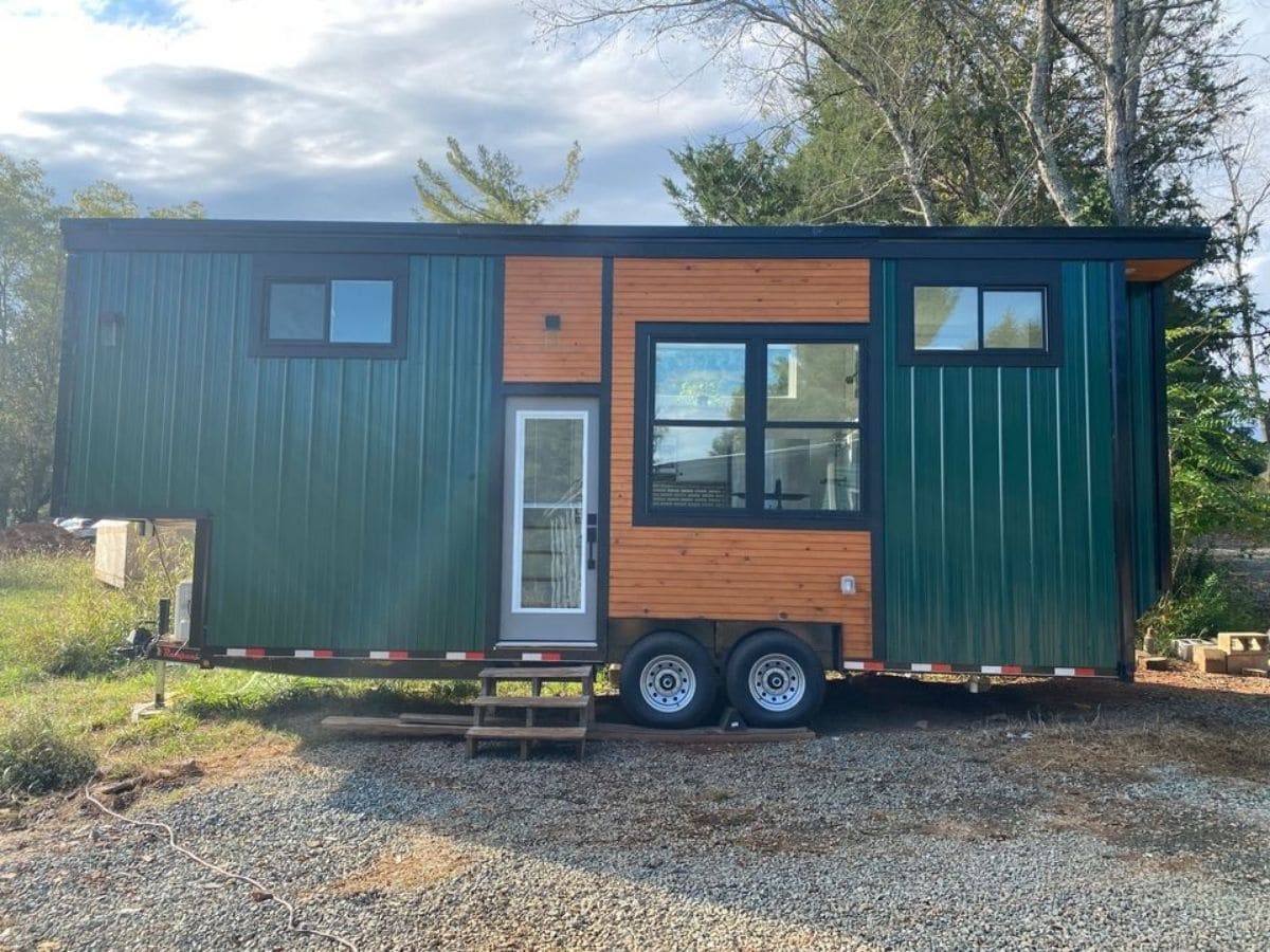 front of tiny home with green siding and wood accents